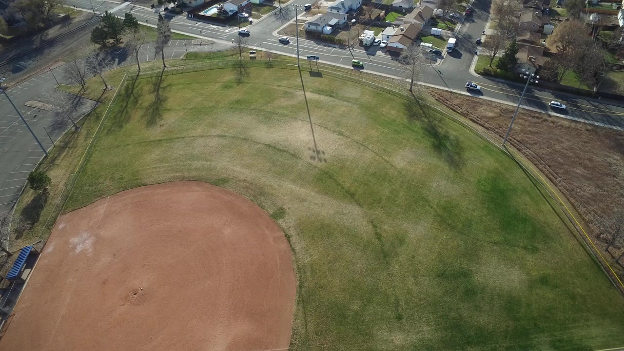 Aerial view of a baseball field beside neighborhood streets.