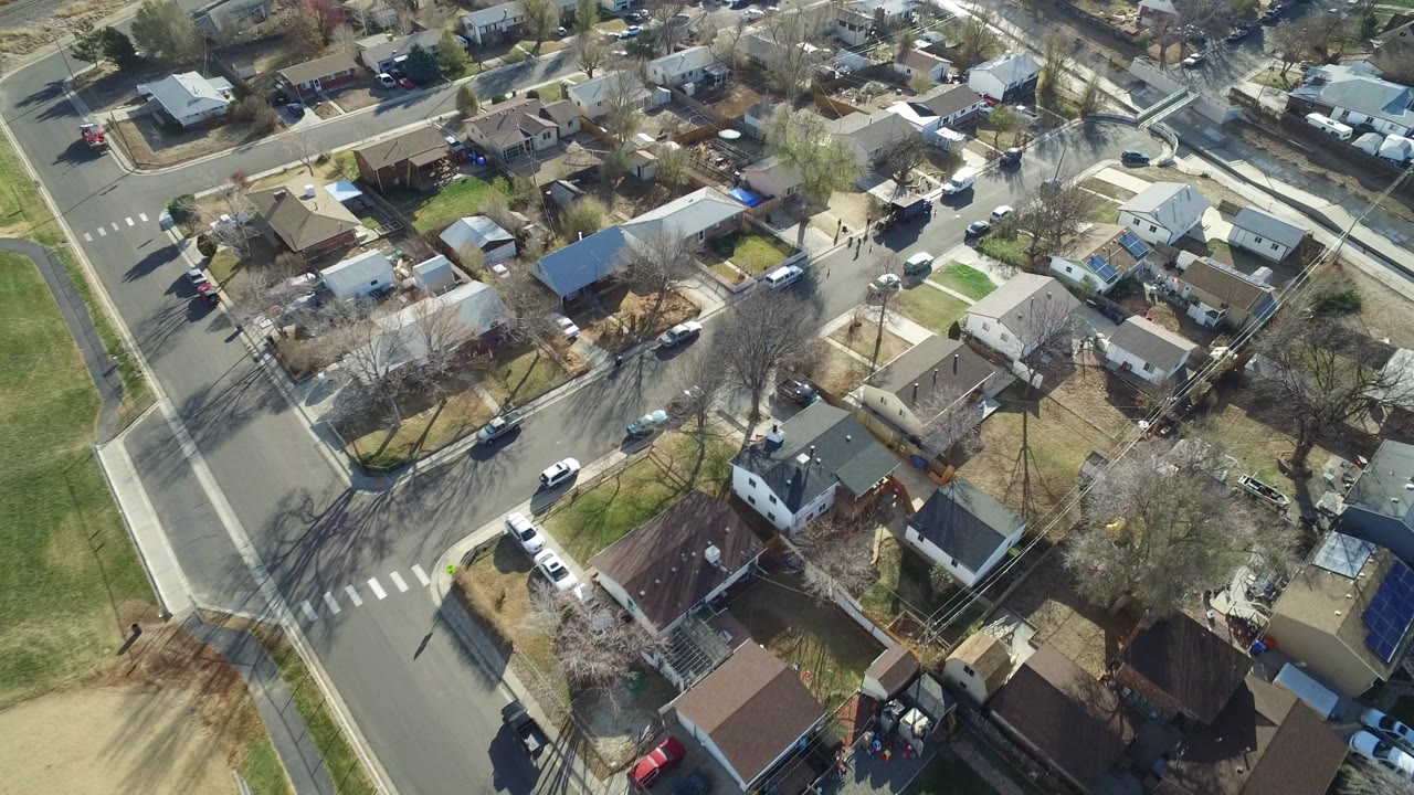 Overhead 2016 view of a Westminster, Colorado residential block with detached homes, sidewalks, leafless trees, parked cars, and no visible people.