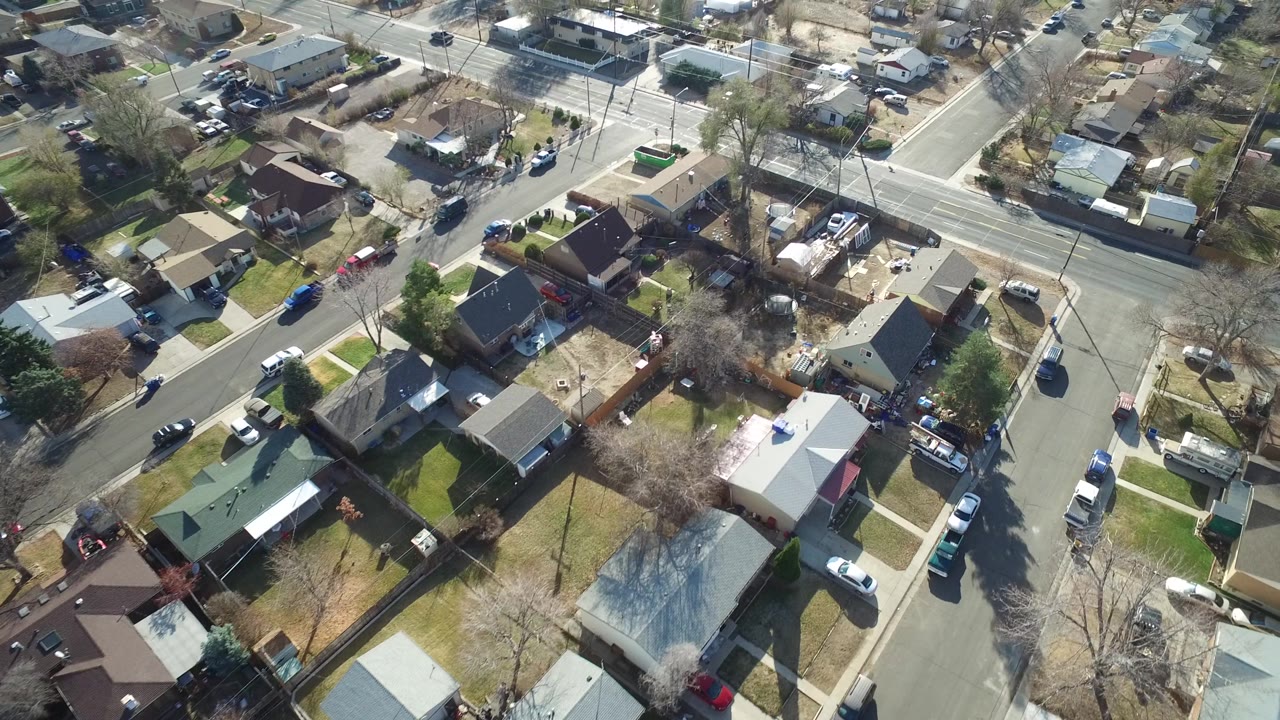 High-angle view of suburban houses around an intersection.