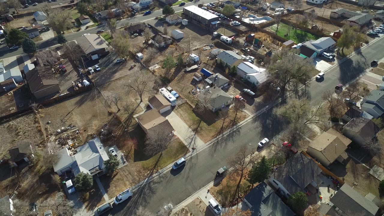 Aerial view over suburban houses and a curved residential street.