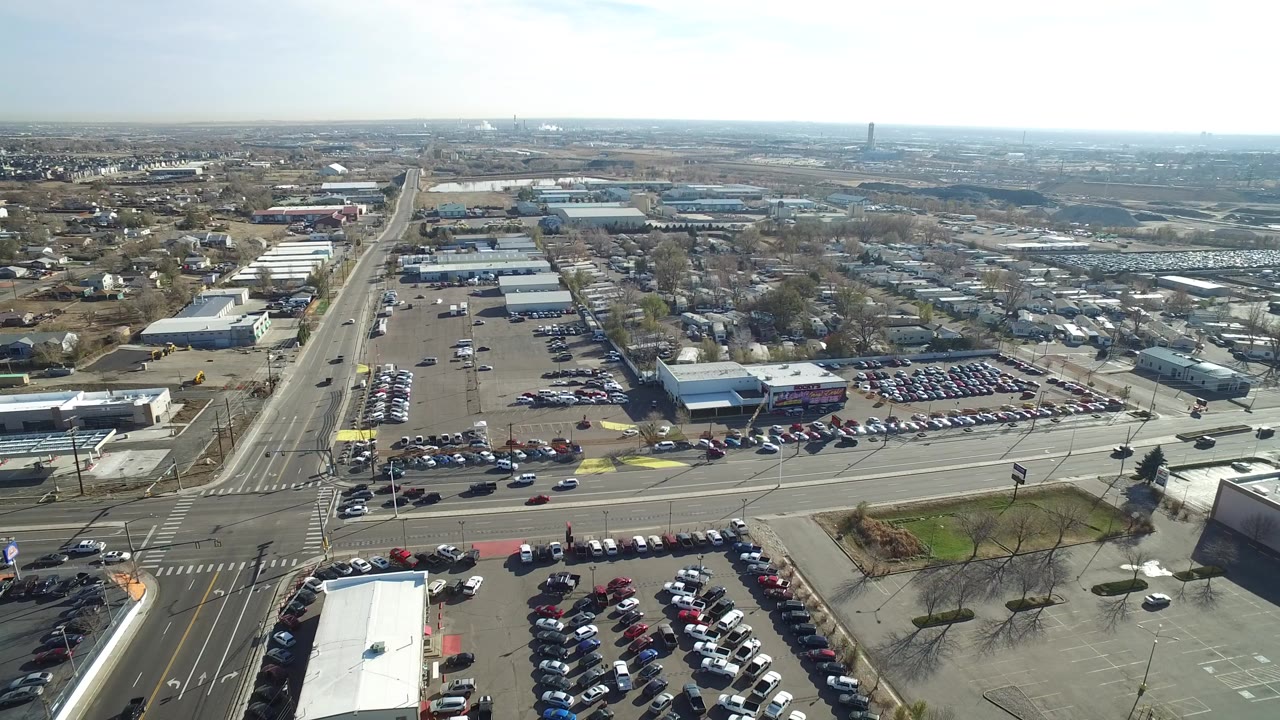 Aerial view of a car dealership beside wide roads