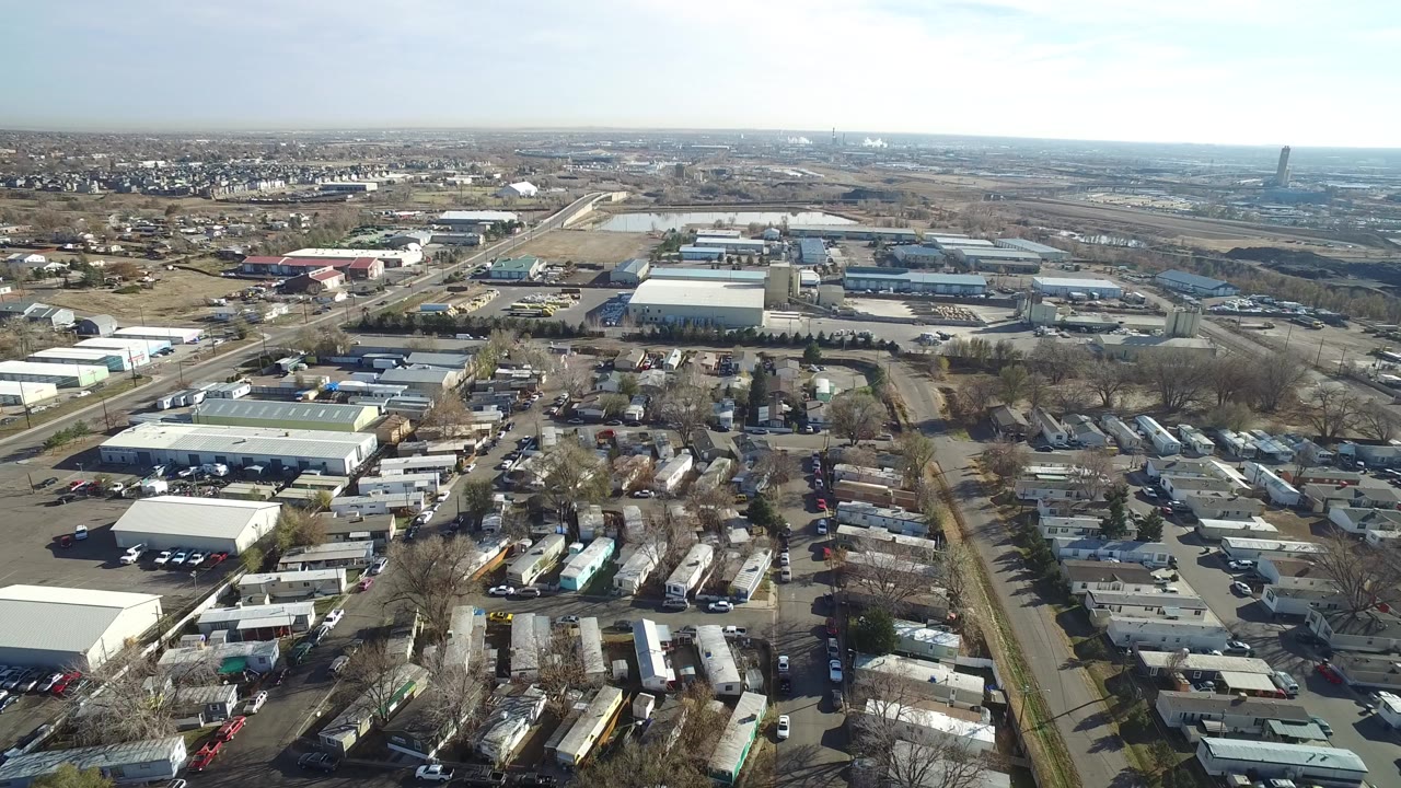 Aerial view of mobile homes, roads, and industrial buildings.