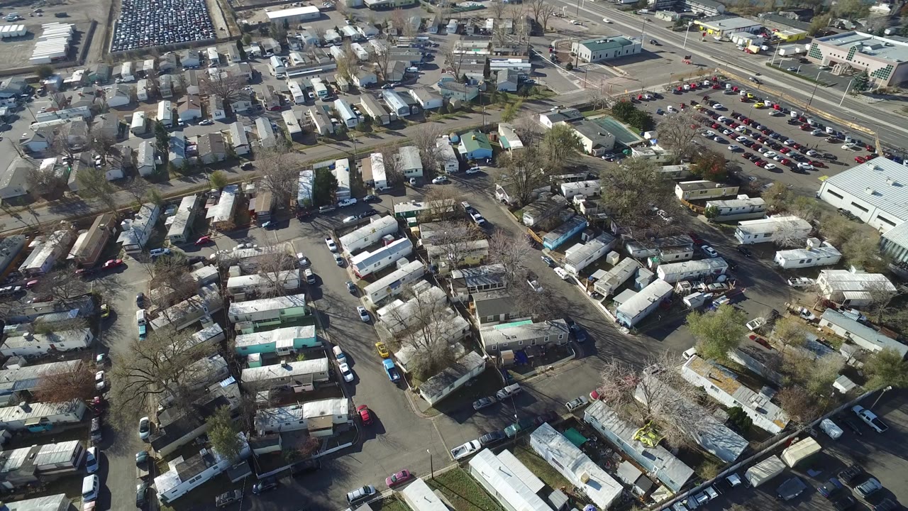 Aerial frame in Westminster, Colorado with the trailer rows centered, a packed vehicle lot toward the upper right, surrounding streets, and no visible people.