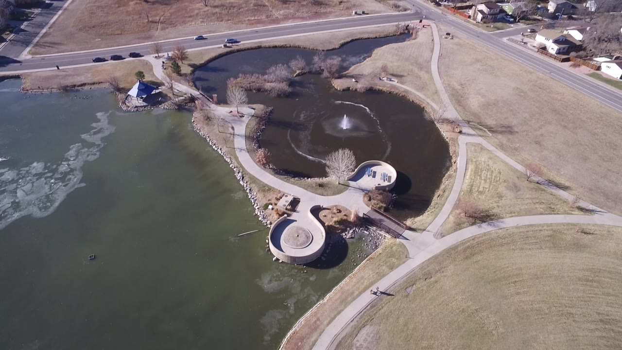Overhead view of two ponds, paths, lawns, and a fountain.