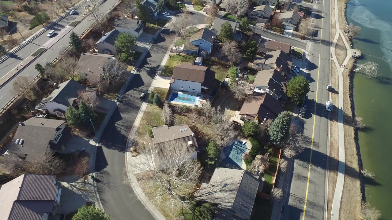 Aerial view of houses beside a road and waterway