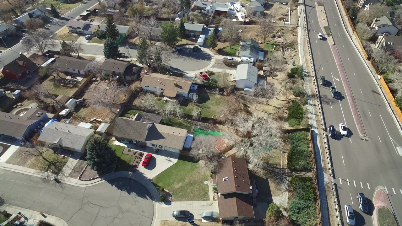 Aerial view of homes beside a multi-lane road.