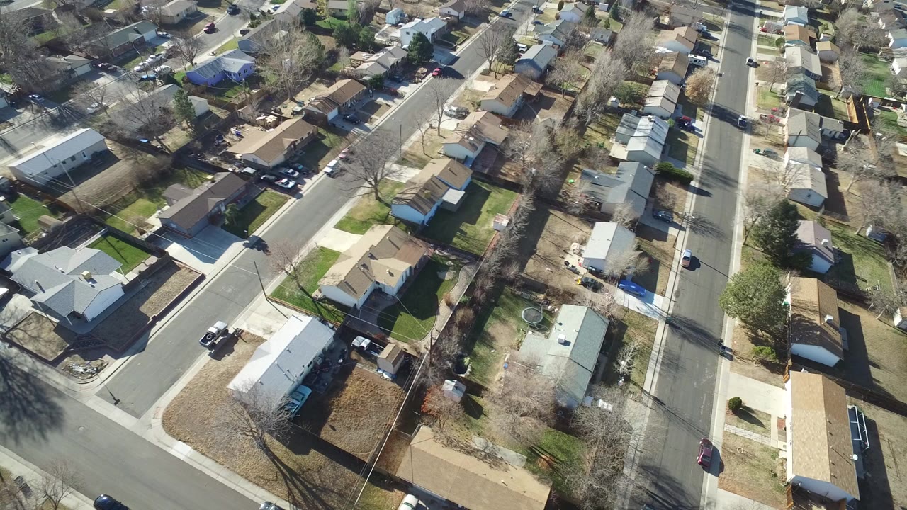 Aerial view of homes and a residential street intersection.