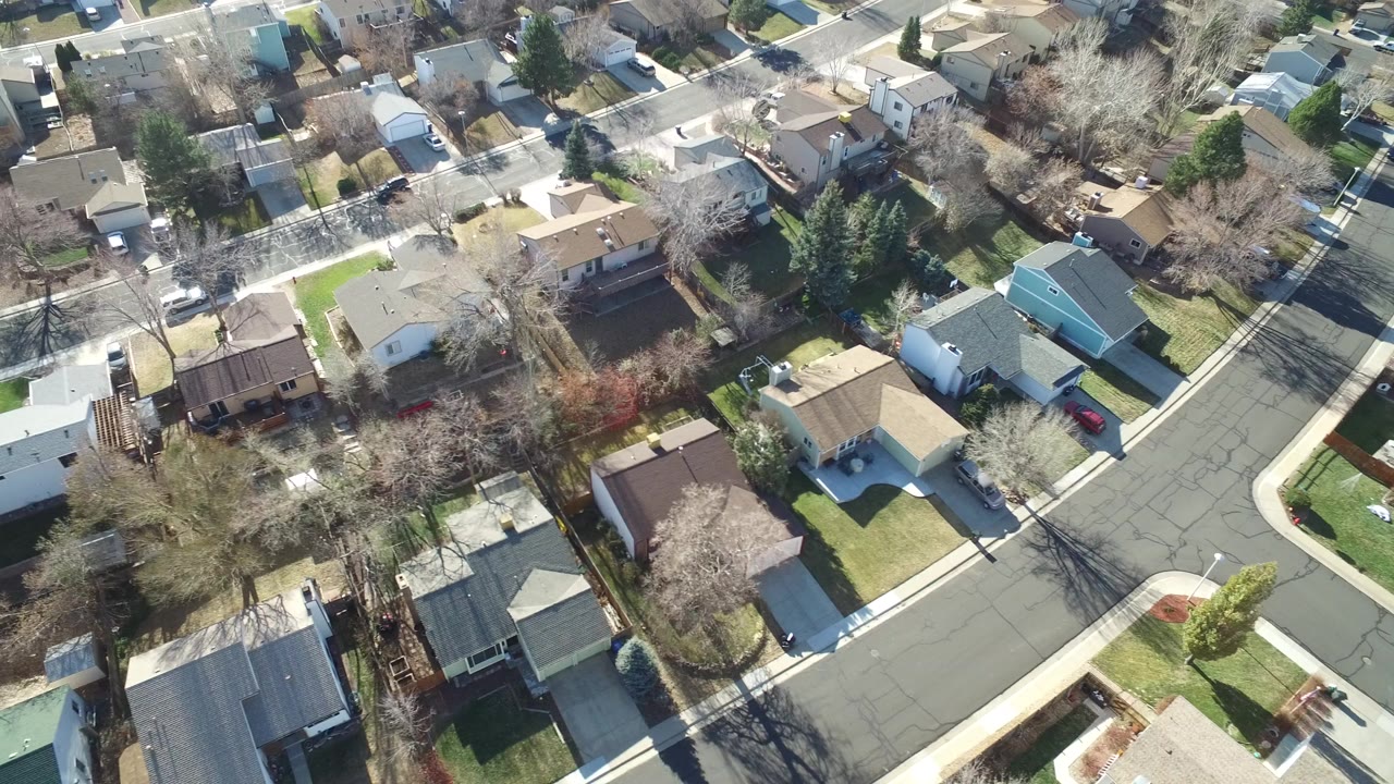 Overhead residential streets with homes, yards, trees, and parked cars.