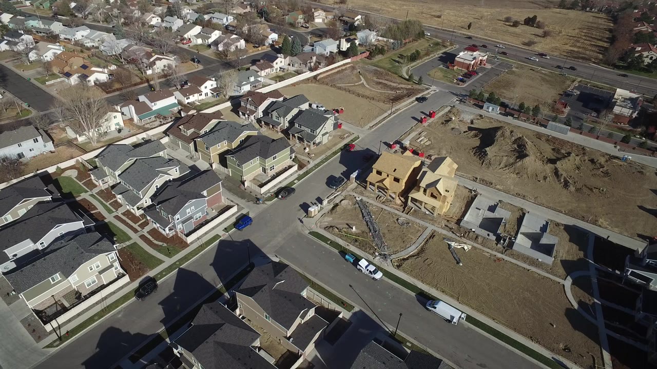 Aerial view of town homes, streets, and construction lots.
