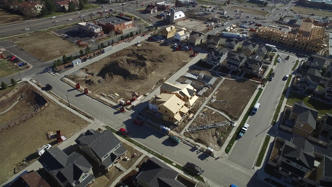 Aerial view of suburban streets, homes, and construction lots.