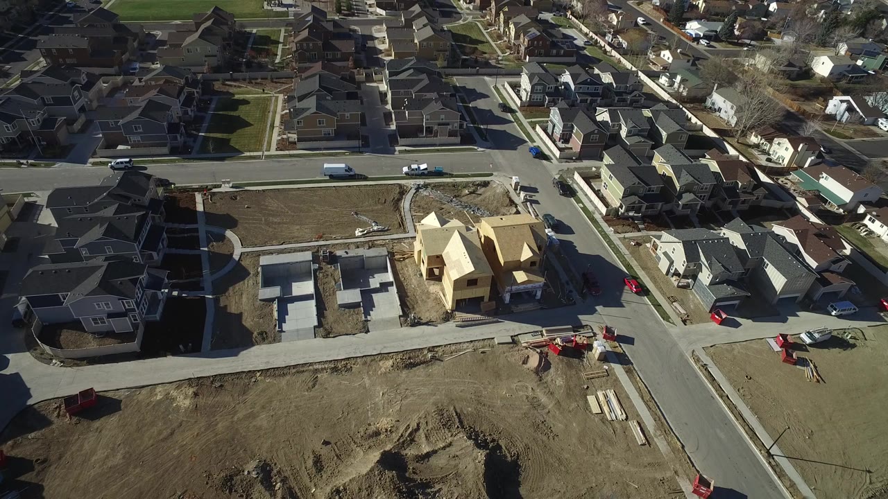 Aerial view of residential streets with new home construction and finished houses.