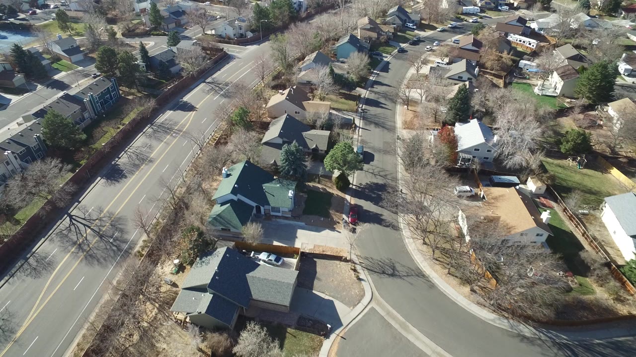 Overhead residential road with homes and bare trees