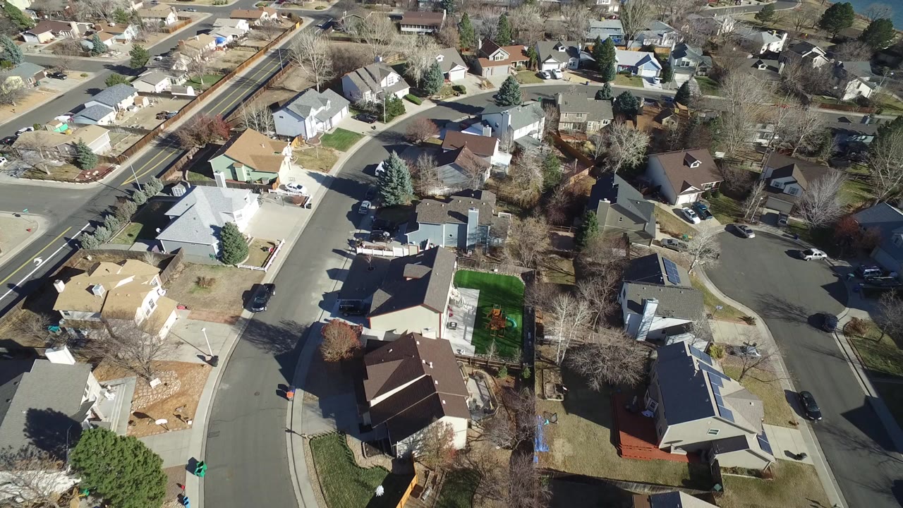Aerial view of suburban homes and curved residential streets.