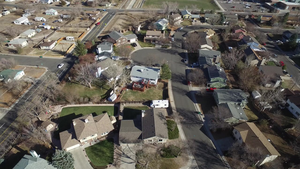 High aerial view of Hidden Lake, Colorado, showing a residential cul-de-sac, detached homes, lawns, driveways, leafless trees, and no visible people.