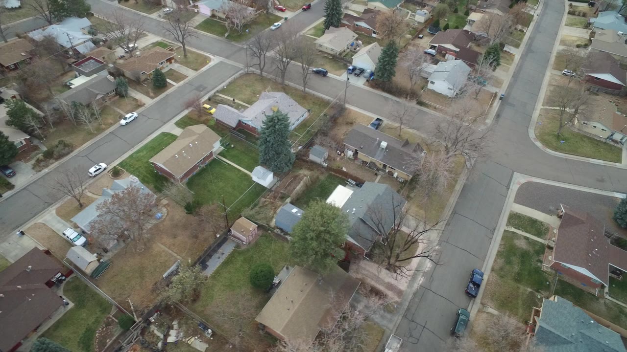 Overhead view of suburban homes and intersecting residential streets.