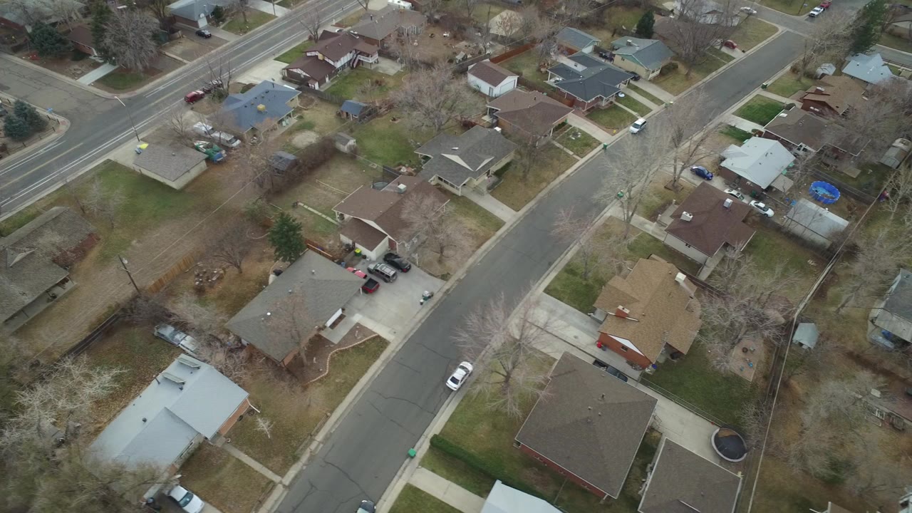 Aerial view of suburban homes and a curved residential street.