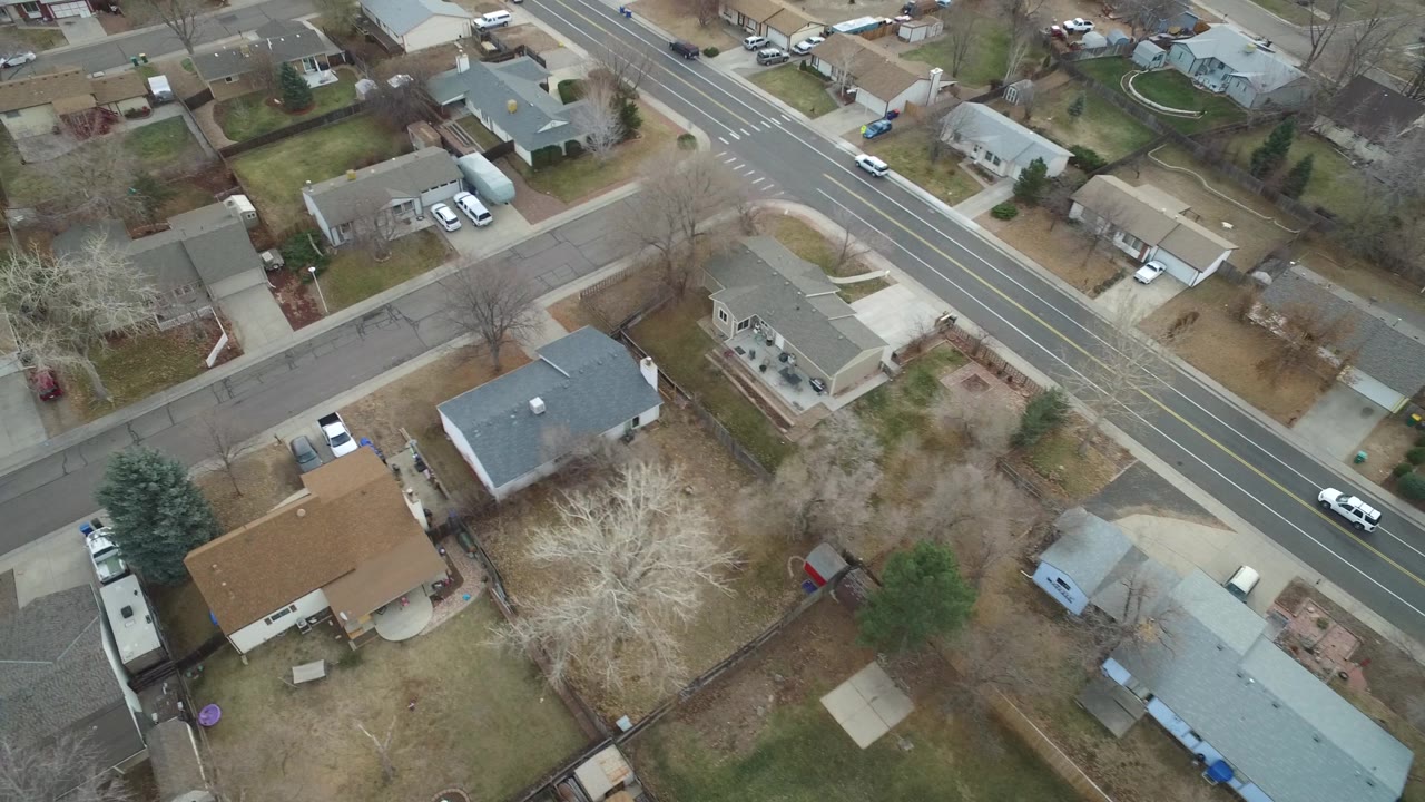 Drone view of a residential block and diagonal road.