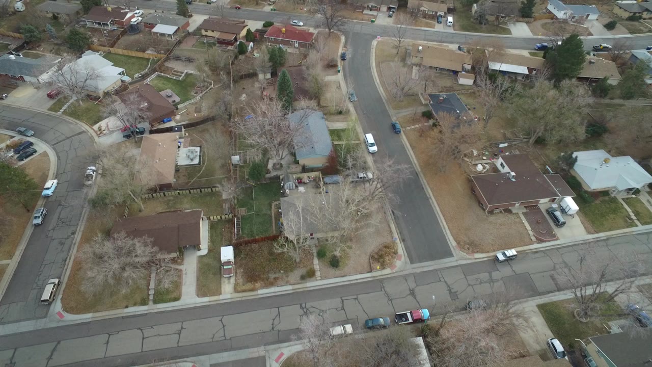 Overhead view of suburban homes and curving residential streets.