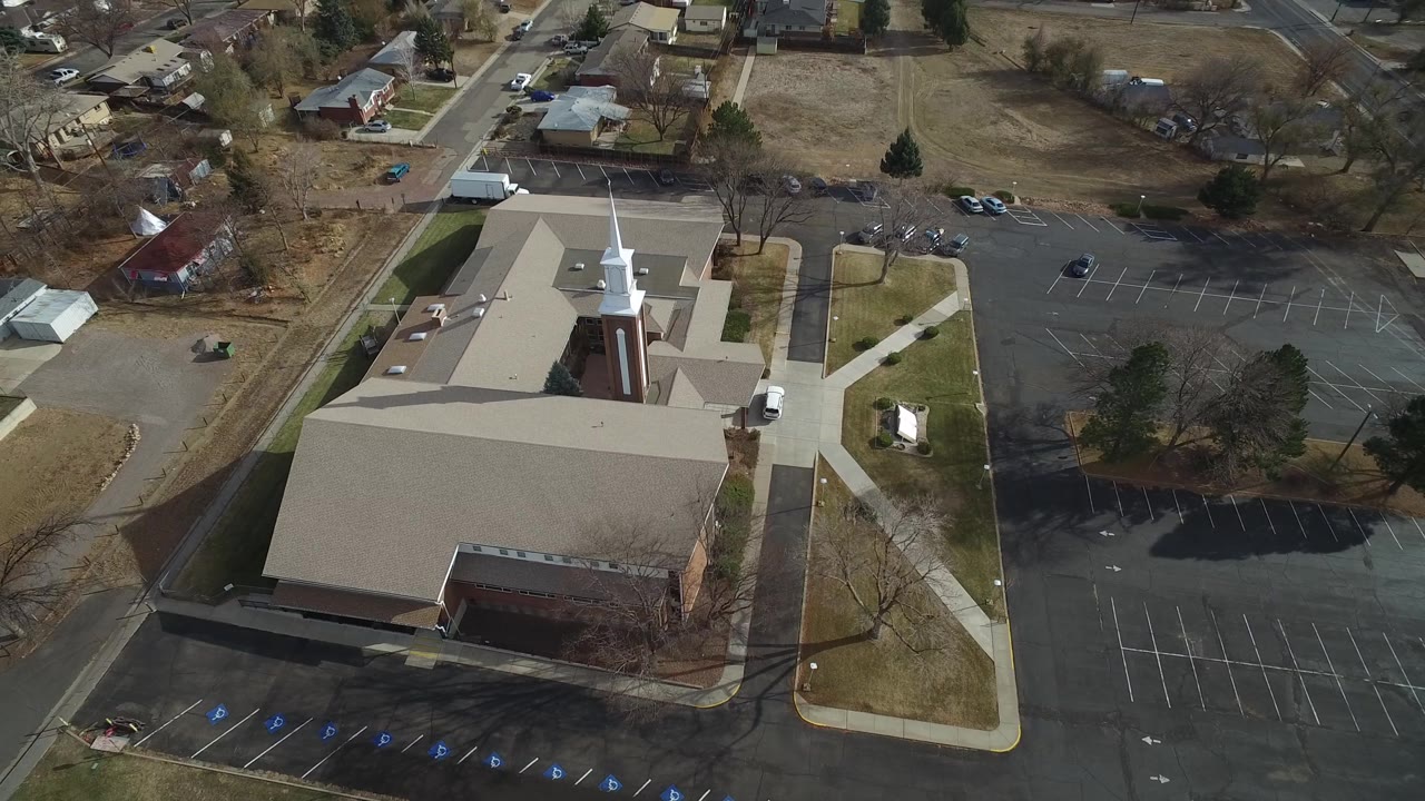Drone-style view of church grounds and adjacent parking lot.