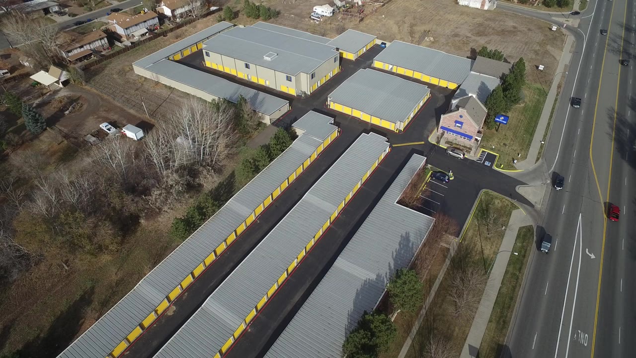 Aerial view of storage buildings beside a multi-lane road