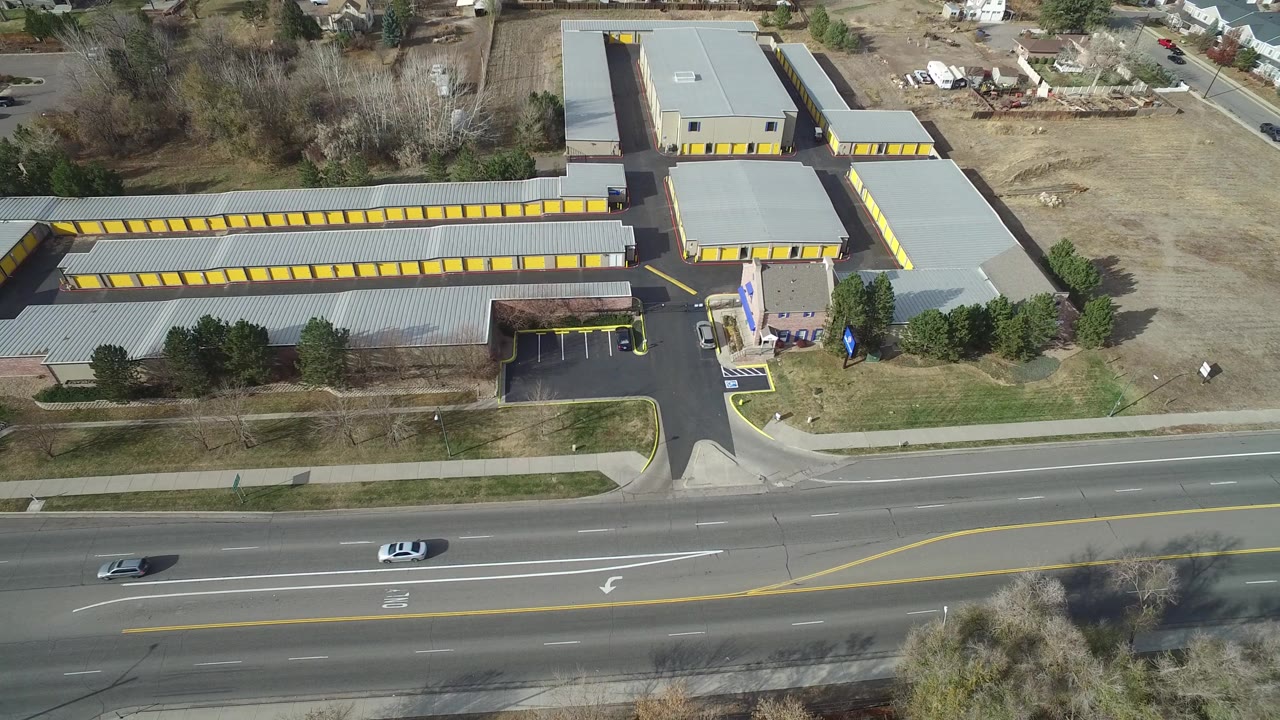 Aerial view of storage buildings beside a multi-lane road.