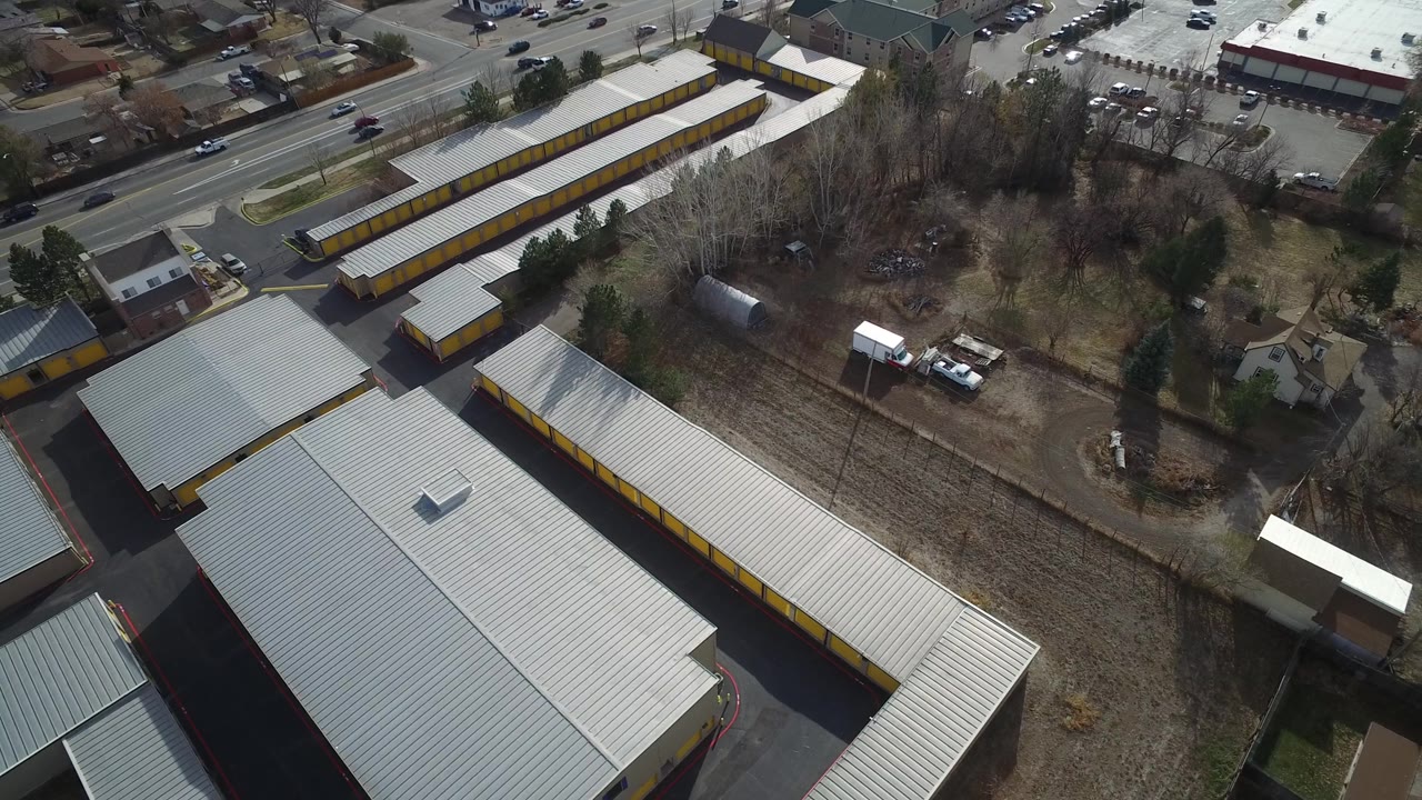 Overhead view of a storage-style complex with houses nearby.