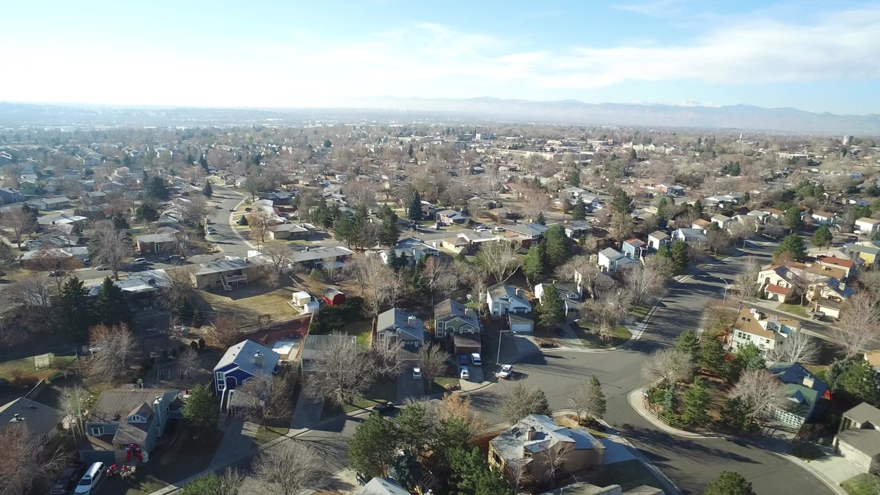 Aerial view over suburban homes and curving roads