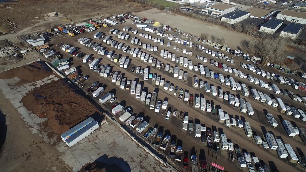 A second overhead angle in Hidden Lake, Colorado shows the trailer rows more centered, with a long white structure near the lower edge and vehicles lining the yard.
