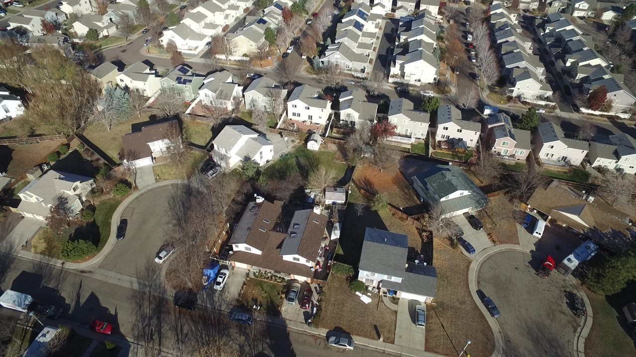 Aerial view of suburban houses and curved streets