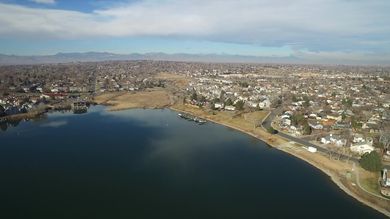 Aerial view of a lake shoreline and residential neighborhood