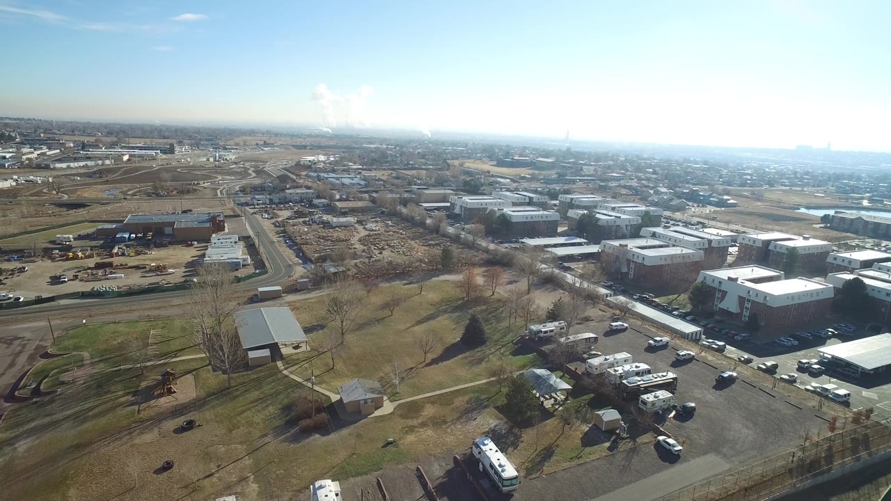 Aerial view of commercial buildings beside roads and open land