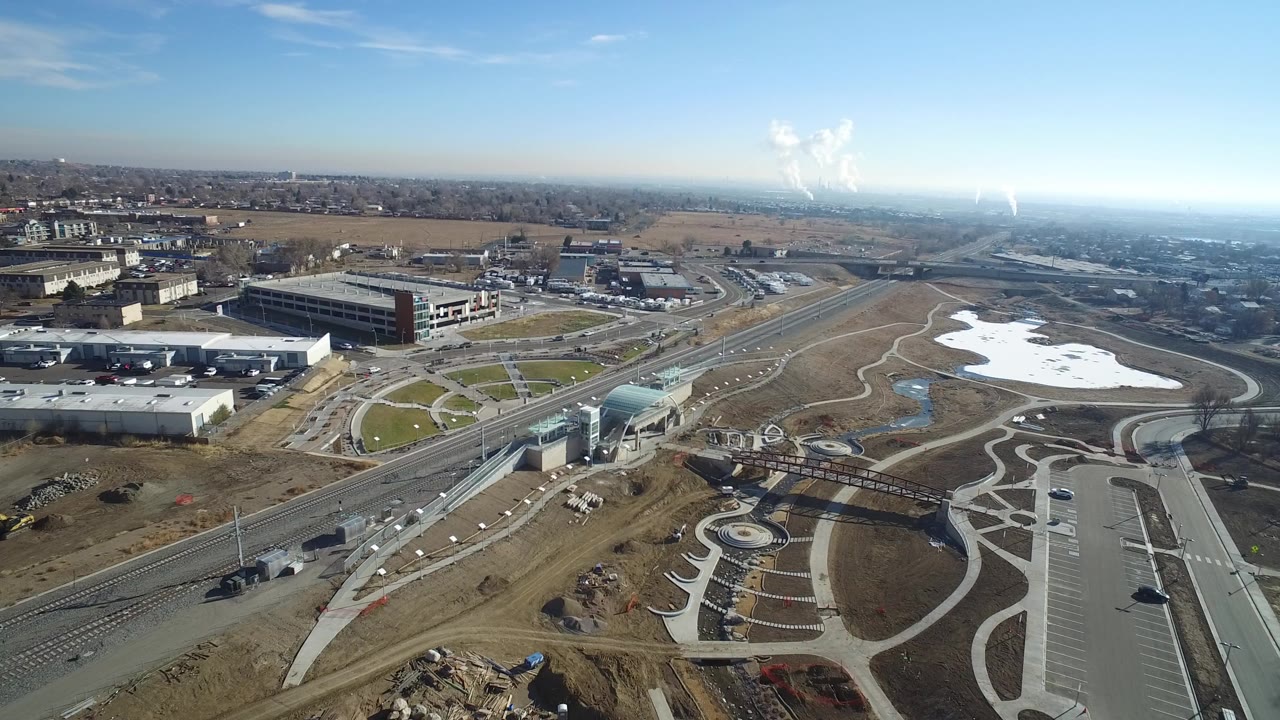 Aerial view of roads, office buildings, paths, and snow patches.