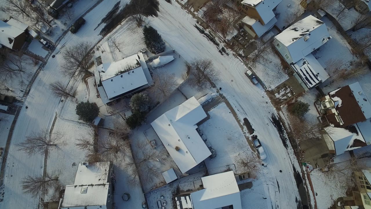 Snowy residential blocks viewed from directly above.