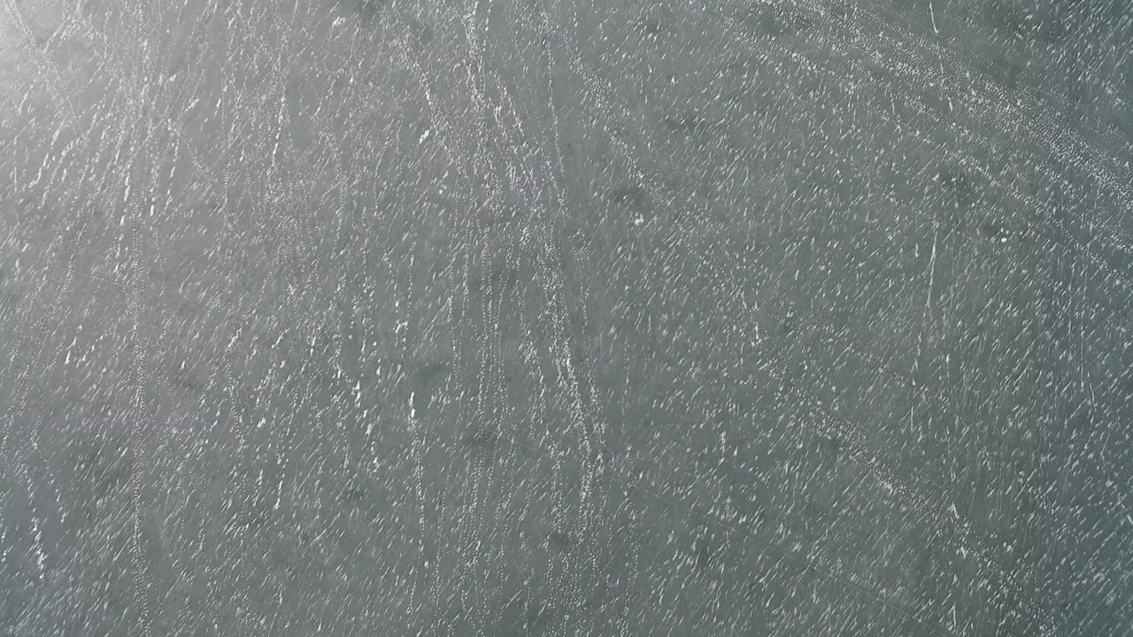 Gray scratched stone surface texture from Hidden Lake, Colorado, filling the frame with no visible people.