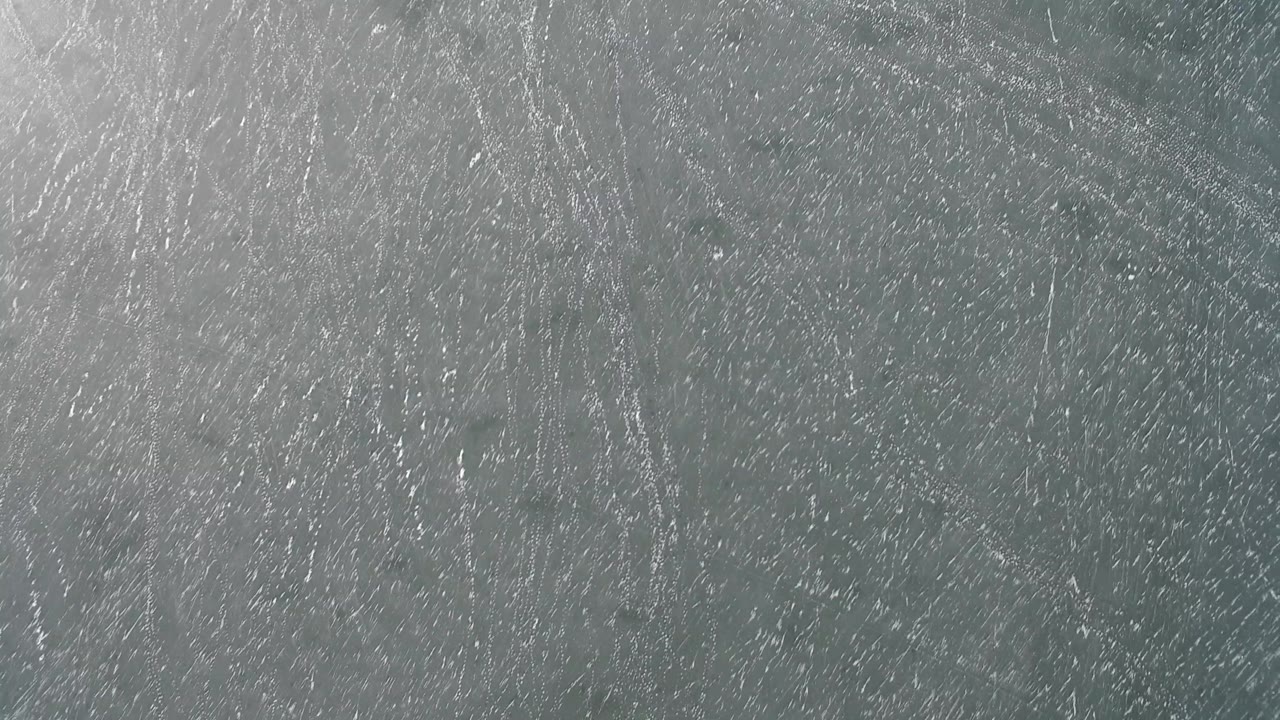 Cool gray rough stone surface in Hidden Lake, Colorado, with fine white scrape marks and no visible people.