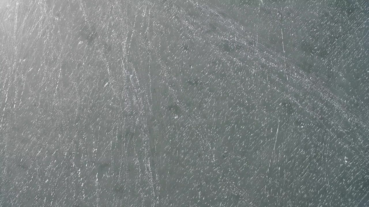 Mottled gray stone texture with light scratches and darker patches.