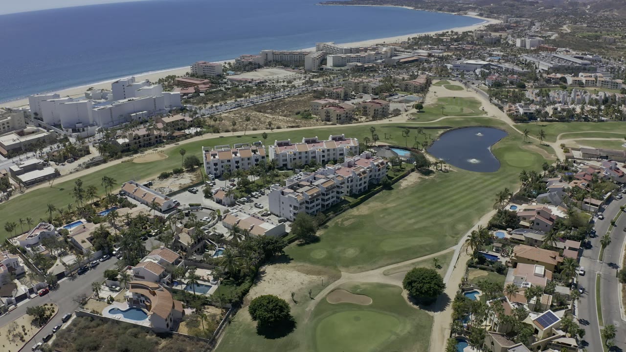 Aerial view of golf course, condos, homes, beach, and ocean