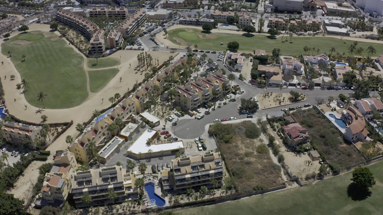 Aerial view of homes, roads, and golf fairways.
