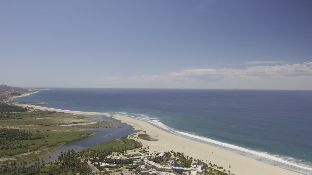 Aerial view of ocean, beach, lagoon, and coastal greenery