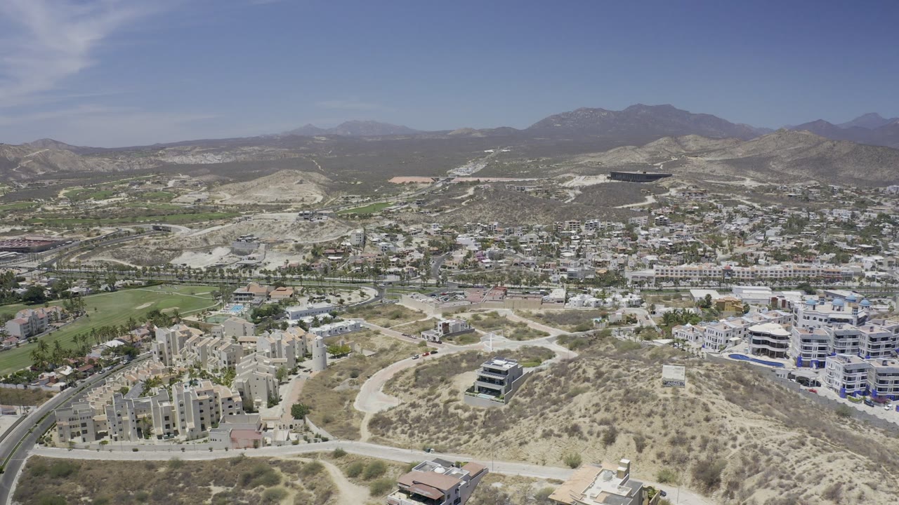 City and hills seen from above under bright sky
