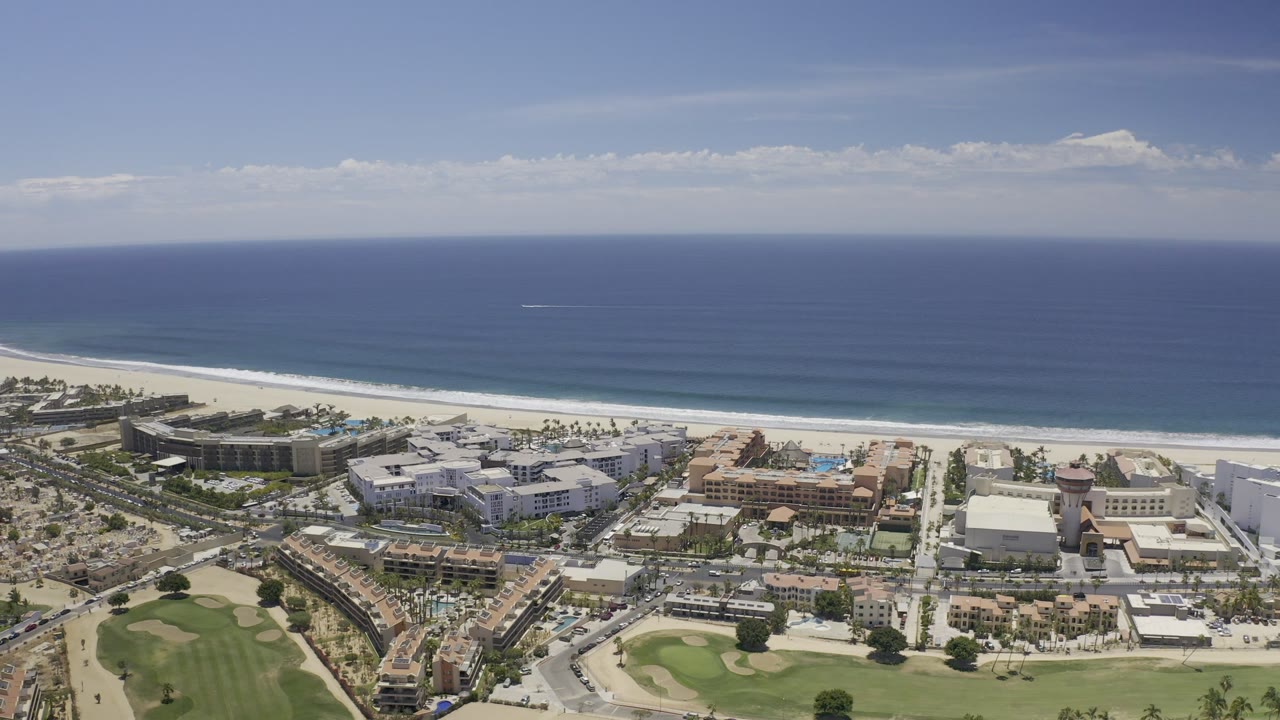 Drone-like aerial view of beach town beside the ocean