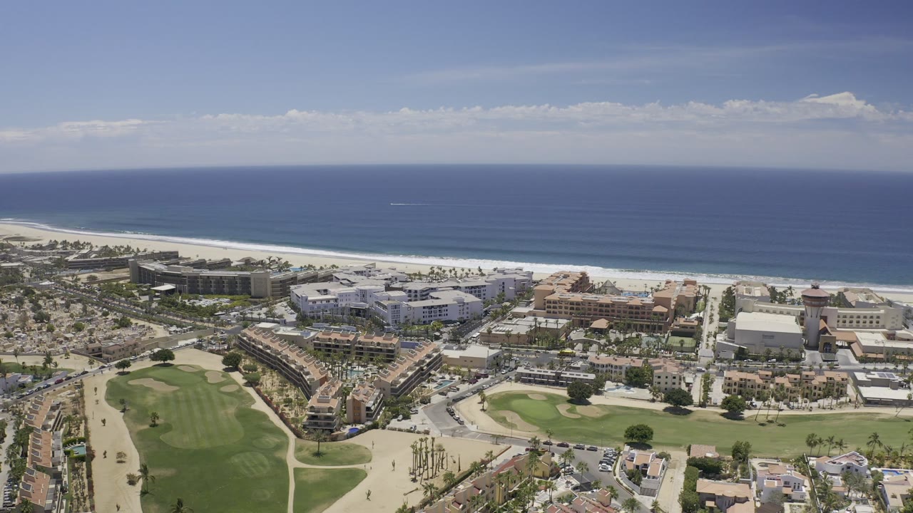 Drone-style view of Los Cabos waterfront development and beach