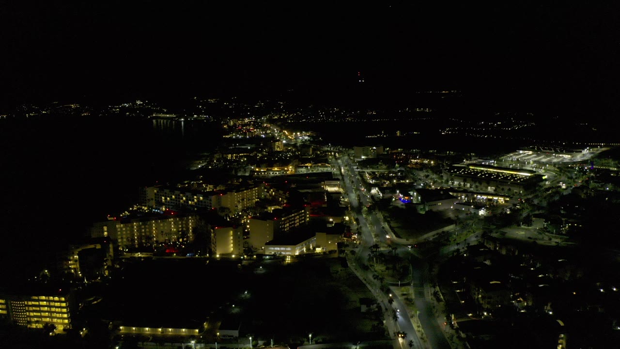 Night aerial view of lit city streets and buildings