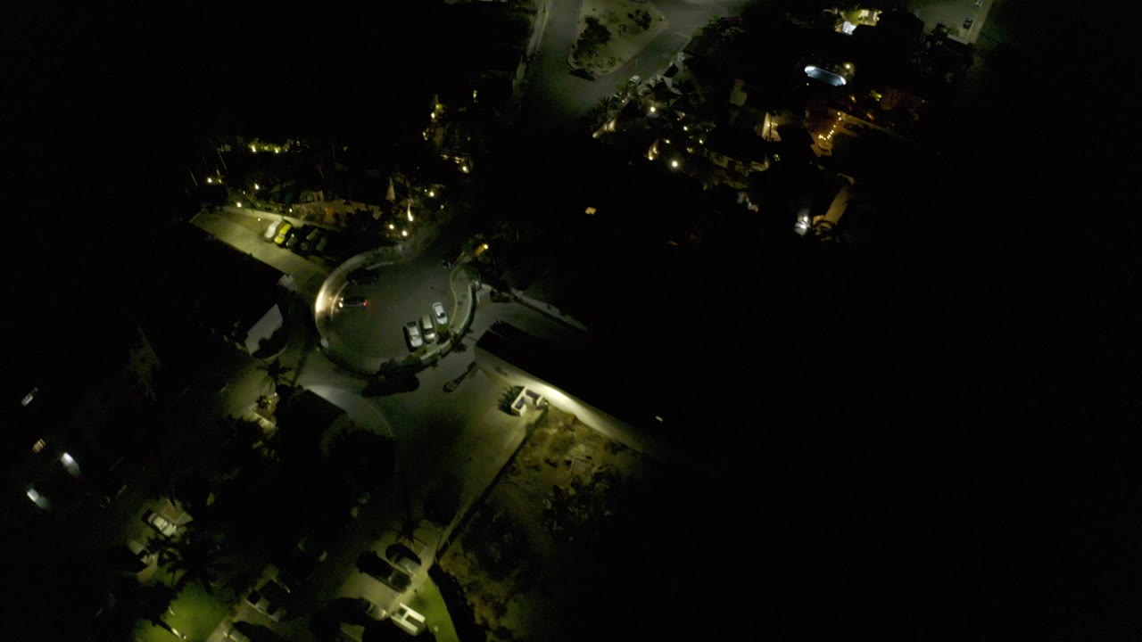 Night aerial view of a lit curved street and buildings
