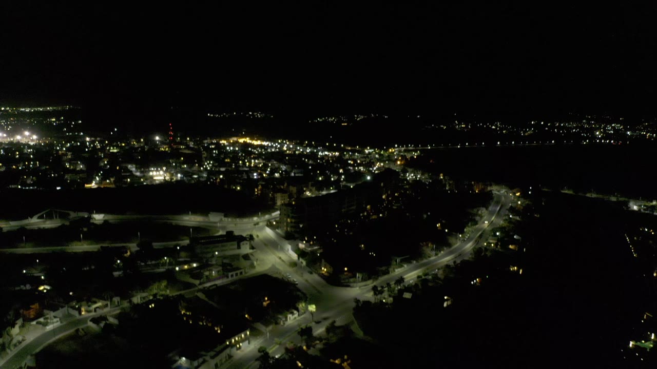 Dark sky over city lights and illuminated roads