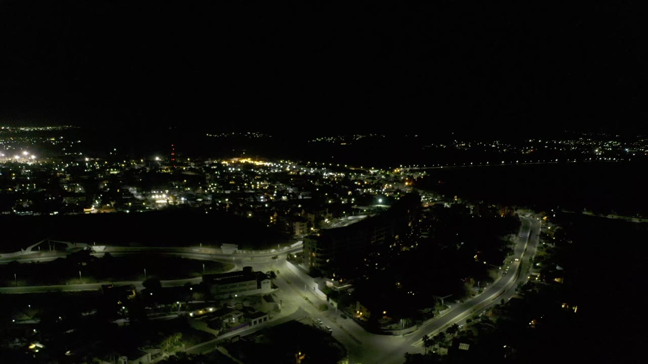 Night city lights with roads crossing the lower frame.