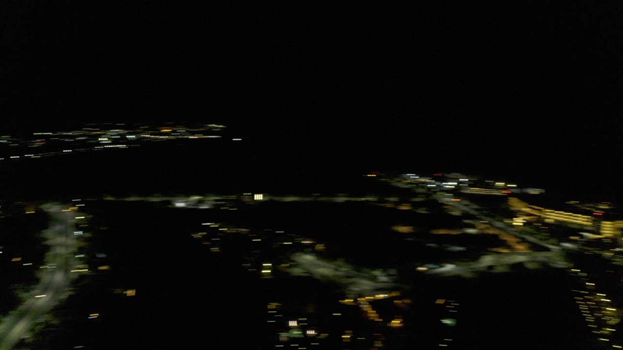 Blurred yellow city lights under a black night sky
