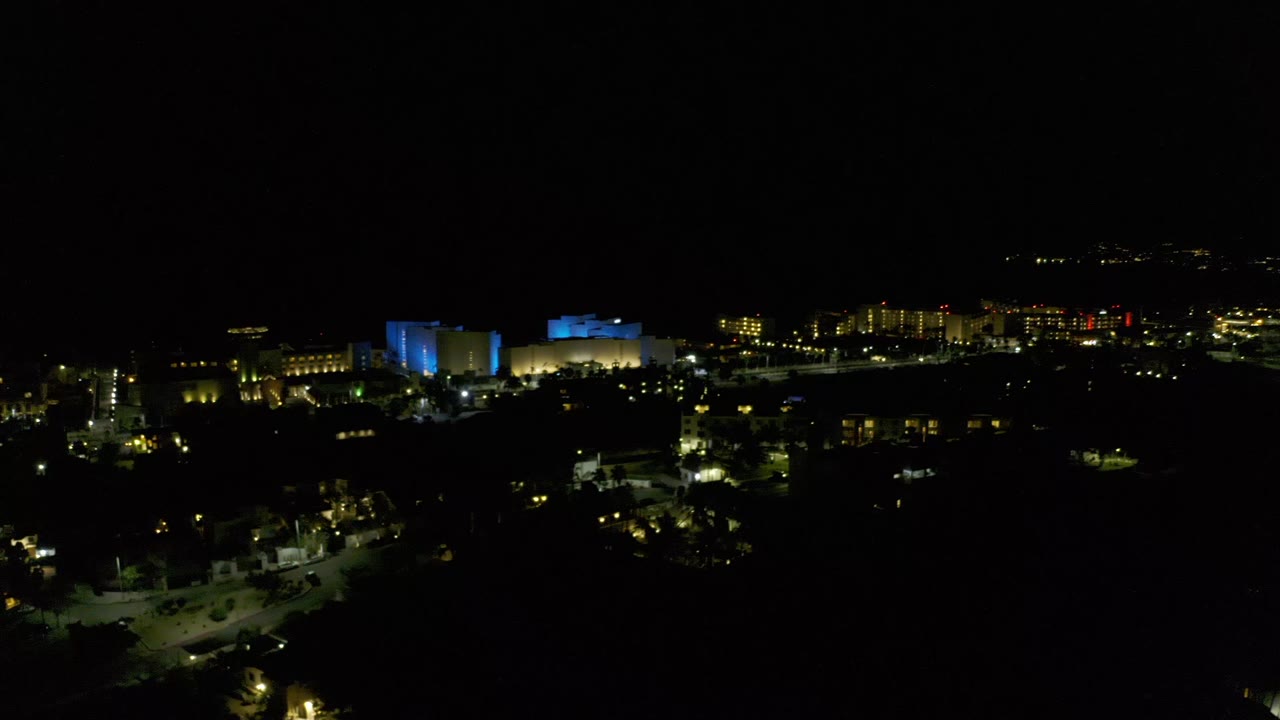Night cityscape with scattered lights and dark foreground