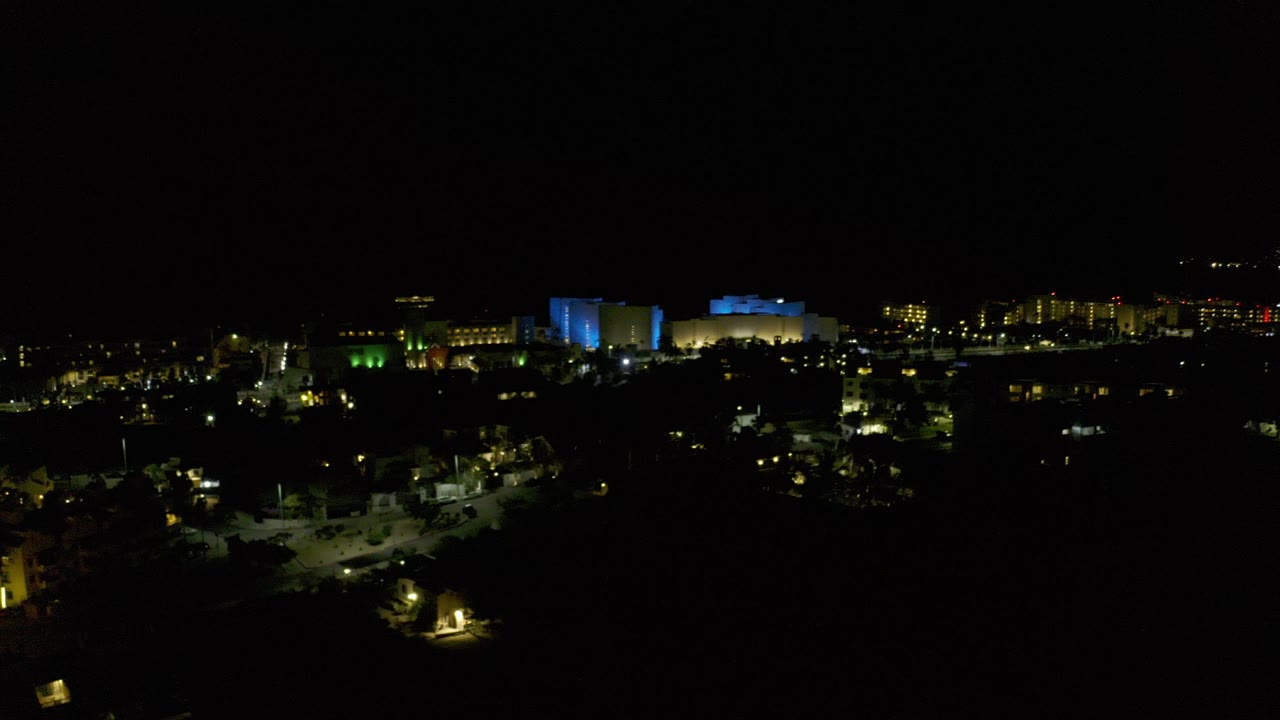 Distant city lights under a black night sky