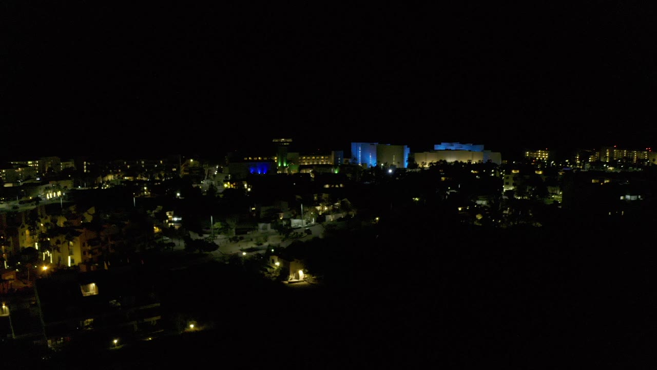 Night city lights under a black sky from a high view.